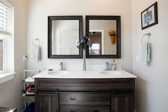 full bath featuring double vanity and a sink