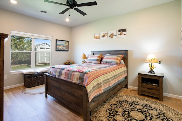 bedroom featuring baseboards, wood finished floors, visible vents, and recessed lighting