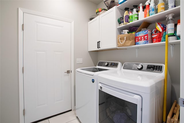 laundry area featuring cabinet space, independent washer and dryer, and light tile patterned floors