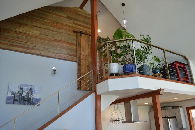 113 Cougar Trl, Whitefish, MT 59937 - staircase featuring recessed lighting, wooden walls, and high vaulted ceiling