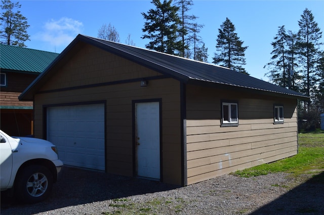 113 Cougar Trl, Whitefish, MT 59937 - view of property exterior with an outdoor structure, a detached garage, and metal roof