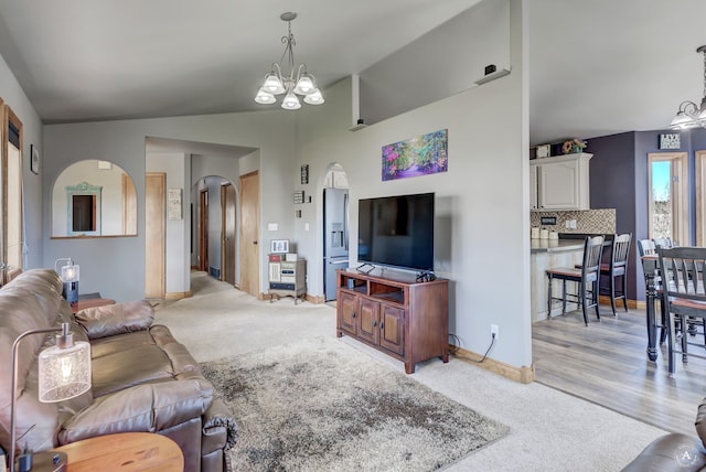 24 Hilltop Dr, Clancy, MT 59634 - living room with arched walkways, a chandelier, light carpet, and lofted ceiling
