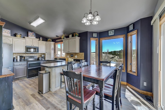 24 Hilltop Dr, Clancy, MT 59634 - dining space with a chandelier, vaulted ceiling, and light wood-style floors