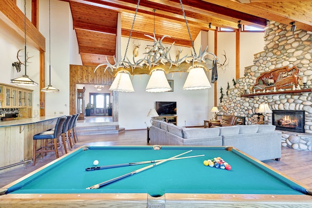 2549 Horseshoe Hills Trl, Seeley Lake, MT 59868 - game room with high vaulted ceiling, wood finished floors, beamed ceiling, billiards, and a fireplace