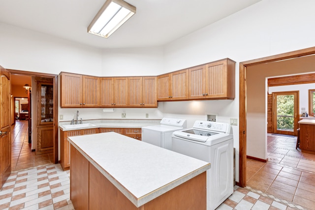 2549 Horseshoe Hills Trl, Seeley Lake, MT 59868 - kitchen featuring washing machine and clothes dryer, light countertops, and a center island