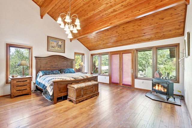 2549 Horseshoe Hills Trl, Seeley Lake, MT 59868 - bedroom with a wood stove, a wood ceiling with exposed beams, access to exterior, a chandelier, and multiple windows