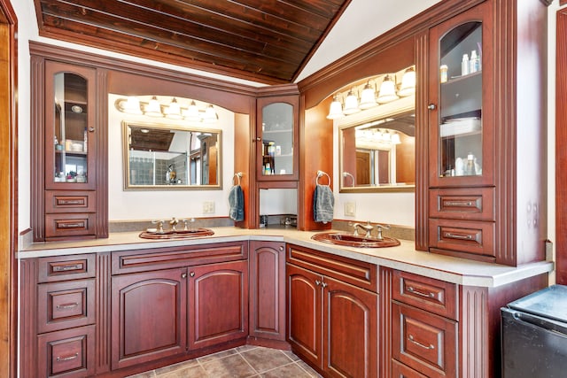 2549 Horseshoe Hills Trl, Seeley Lake, MT 59868 - full bathroom featuring vaulted ceiling, double vanity, wooden ceiling, and tile patterned flooring
