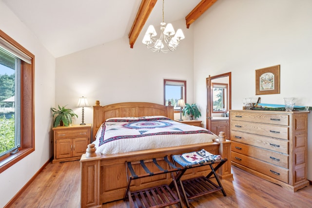 2549 Horseshoe Hills Trl, Seeley Lake, MT 59868 - bedroom with a chandelier, multiple windows, and light wood-style flooring