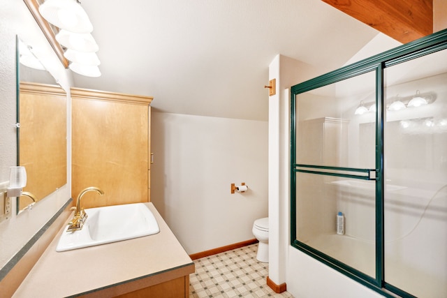 2549 Horseshoe Hills Trl, Seeley Lake, MT 59868 - bathroom with tile patterned floors, vanity, vaulted ceiling, and combined bath / shower with glass door