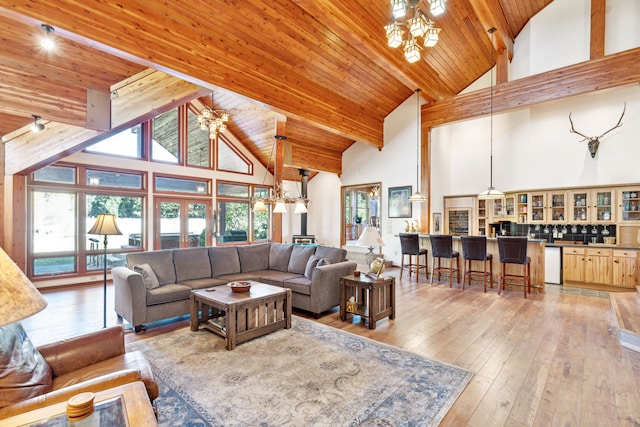 2549 Horseshoe Hills Trl, Seeley Lake, MT 59868 - living room featuring high vaulted ceiling, light wood-type flooring, a wood ceiling with exposed beams, and a chandelier