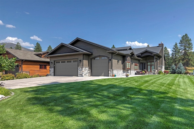 780 Anglers Bend Way, Missoula, MT 59802 - view of front of home featuring a front lawn, driveway, stone siding, and a garage