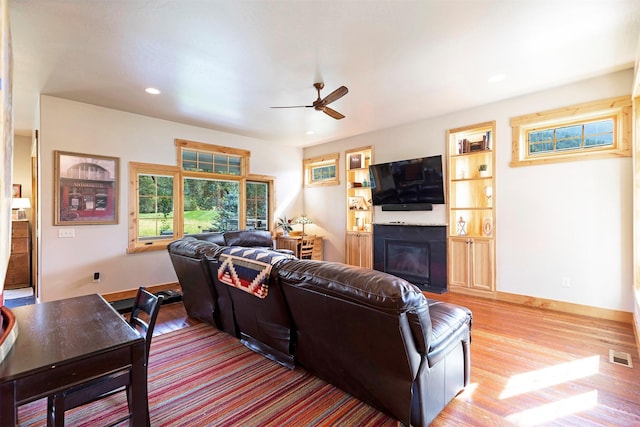 780 Anglers Bend Way, Missoula, MT 59802 - living area with wood finished floors, a glass covered fireplace, ceiling fan, visible vents, and recessed lighting