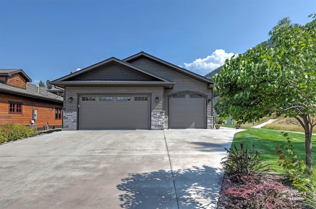 780 Anglers Bend Way, Missoula, MT 59802 - ranch-style house featuring stone siding, an attached garage, a front lawn, and driveway