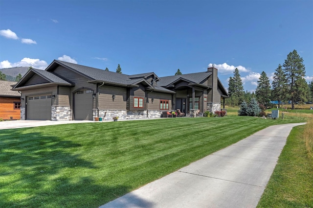 780 Anglers Bend Way, Missoula, MT 59802 - view of front facade featuring stone siding, an attached garage, a chimney, and a front yard