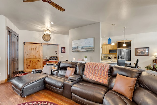 780 Anglers Bend Way, Missoula, MT 59802 - living room with a barn door, wood finished floors, a ceiling fan, and recessed lighting