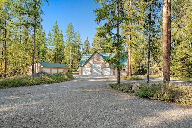 675 Beaver Lake Rd, Whitefish, MT 59937 - view of front facade featuring a detached garage and driveway