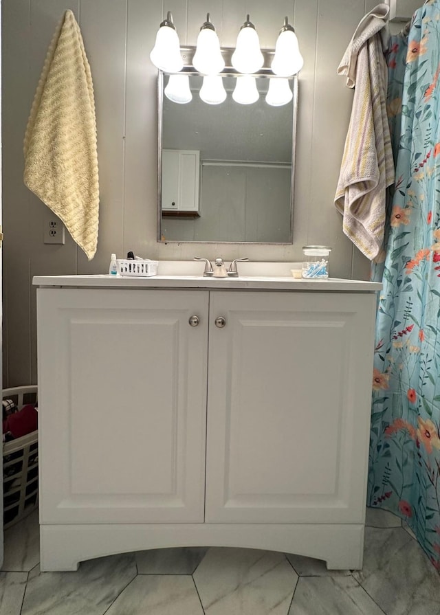 bathroom with marble finish floor and vanity