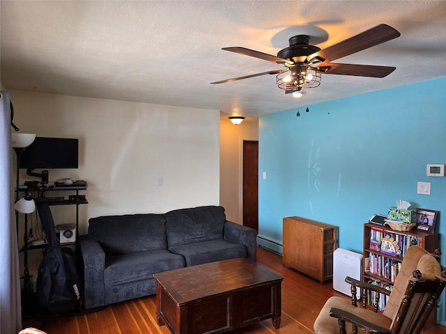 living room with a ceiling fan and wood finished floors