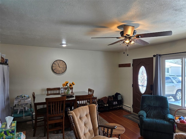 living area with a textured ceiling, wood finished floors, a healthy amount of sunlight, and ceiling fan