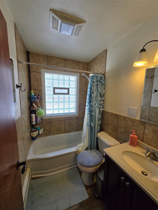 full bathroom featuring a textured ceiling, tile walls, visible vents, baseboard heating, and shower / tub combo with curtain