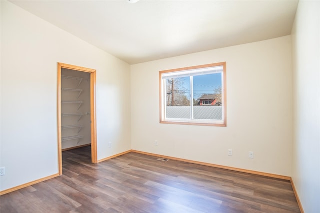 2226 Burlington Ave Unit A, Missoula, MT 59801 - empty room featuring baseboards, vaulted ceiling, wood finished floors, and visible vents