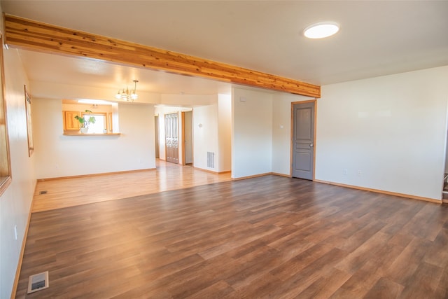 2226 Burlington Ave Unit A, Missoula, MT 59801 - empty room with visible vents, wood finished floors, a chandelier, and beamed ceiling
