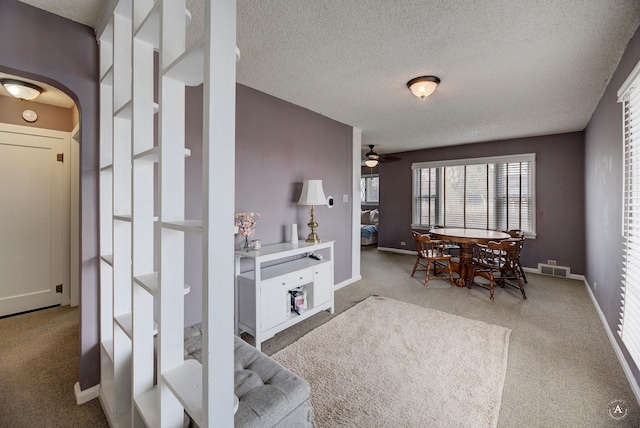 730 N Montana Ave, Helena, MT 59601 - dining area featuring arched walkways, a textured ceiling, carpet flooring, and ceiling fan
