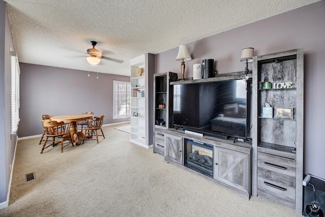 730 N Montana Ave, Helena, MT 59601 - living area featuring visible vents, a ceiling fan, baseboards, a textured ceiling, and carpet flooring