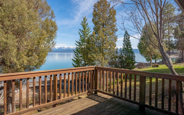 wooden deck featuring a yard and a water view