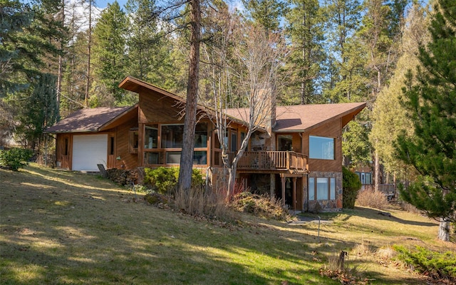 exterior space featuring an attached garage, stone siding, and a front yard