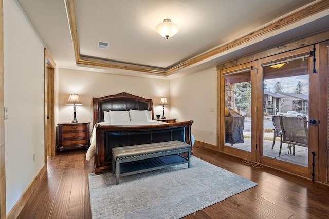 105 Oliver Ln Unit 7, Bigfork, MT 59911 - bedroom featuring a raised ceiling, access to exterior, and wood finished floors