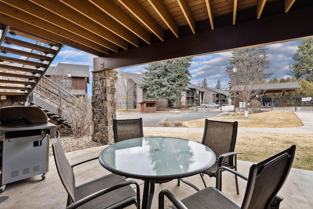 105 Oliver Ln Unit 7, Bigfork, MT 59911 - view of patio featuring outdoor dining area, a shed, area for grilling, and a residential view
