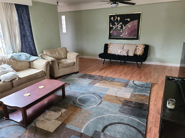 living room featuring wood finished floors, baseboards, a ceiling fan, and visible vents