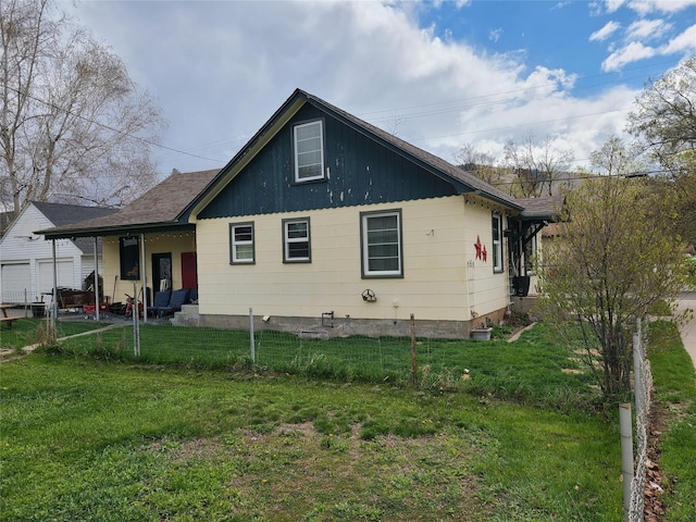 view of side of home with board and batten siding and fence