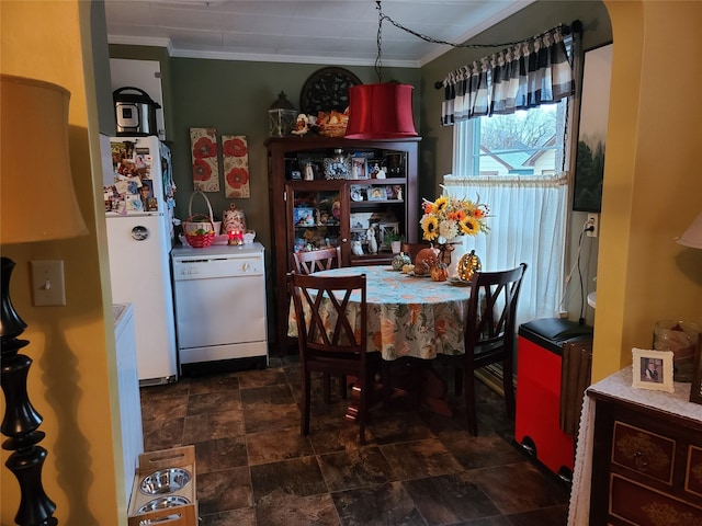 dining space featuring arched walkways, radiator heating unit, stone finish flooring, and crown molding
