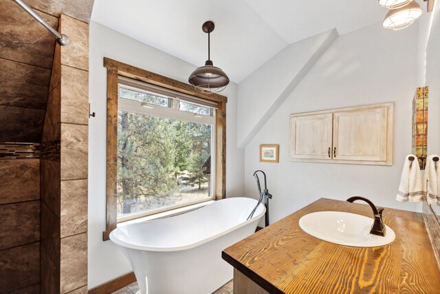 5608 Trinity Way, Florence, MT 59833 - full bathroom featuring a soaking tub, lofted ceiling, vanity, and a shower