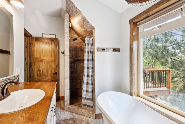5608 Trinity Way, Florence, MT 59833 - bathroom with a tile shower, a freestanding tub, and vanity