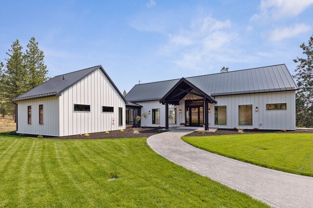 5608 Trinity Way, Florence, MT 59833 - modern inspired farmhouse with board and batten siding, a front yard, and metal roof