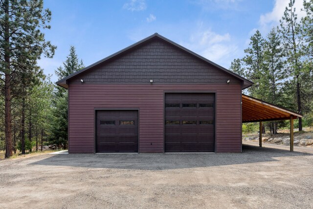5608 Trinity Way, Florence, MT 59833 - garage with a detached garage and dirt driveway