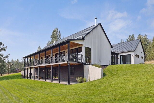 5608 Trinity Way, Florence, MT 59833 - rear view of house featuring a standing seam roof, a deck, a yard, and metal roof