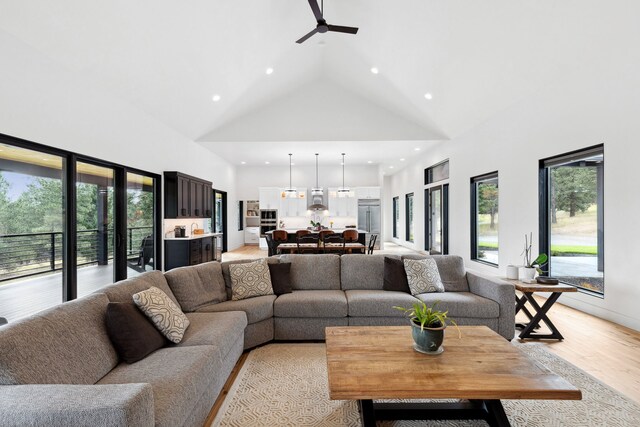 5608 Trinity Way, Florence, MT 59833 - living room featuring recessed lighting, high vaulted ceiling, light wood-style floors, and ceiling fan