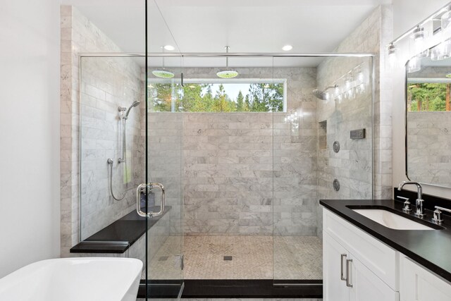 5608 Trinity Way, Florence, MT 59833 - bathroom featuring a shower stall, a healthy amount of sunlight, vanity, and a soaking tub
