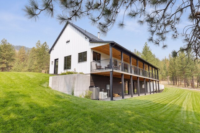 5608 Trinity Way, Florence, MT 59833 - back of property featuring a wooden deck, a yard, and central AC