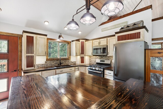 5608 Trinity Way, Florence, MT 59833 - kitchen with backsplash, appliances with stainless steel finishes, a sink, and vaulted ceiling with beams
