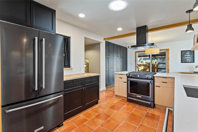 4210 Lincoln Rd, Missoula, MT 59802 - kitchen with island exhaust hood, recessed lighting, high quality appliances, light countertops, and light tile patterned floors