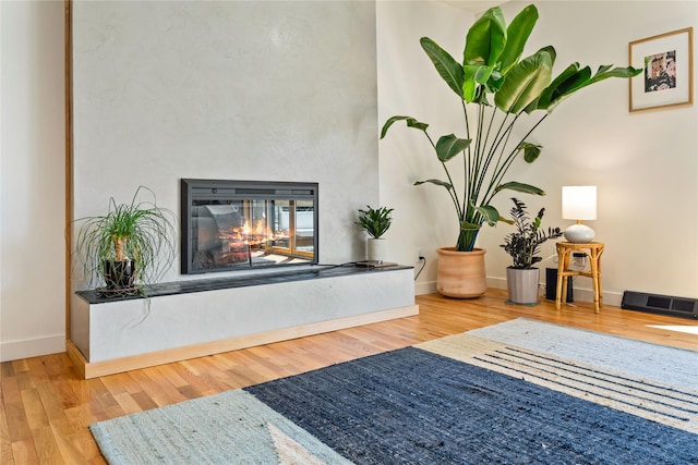 4210 Lincoln Rd, Missoula, MT 59802 - details with a multi sided fireplace, visible vents, wood finished floors, and baseboards