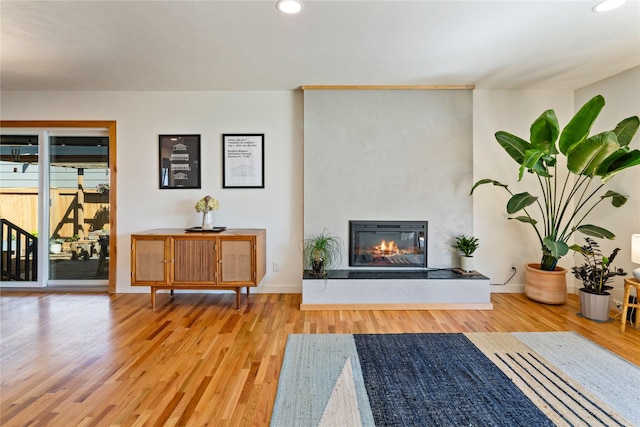 4210 Lincoln Rd, Missoula, MT 59802 - living room featuring wood finished floors, a glass covered fireplace, and recessed lighting