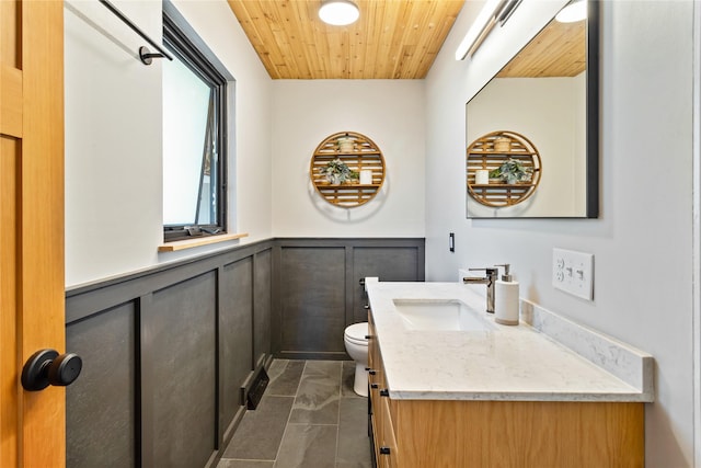 4210 Lincoln Rd, Missoula, MT 59802 - bathroom with toilet, a decorative wall, a wainscoted wall, vanity, and wooden ceiling