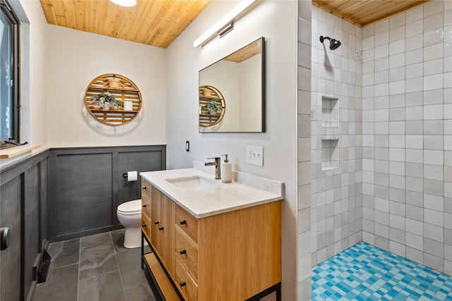 4210 Lincoln Rd, Missoula, MT 59802 - full bathroom featuring wooden ceiling, toilet, wainscoting, tiled shower, and vanity