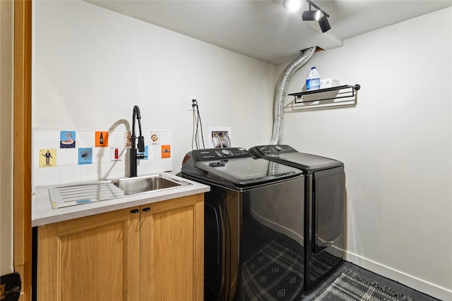 4210 Lincoln Rd, Missoula, MT 59802 - laundry room featuring cabinet space, washing machine and clothes dryer, baseboards, and a sink